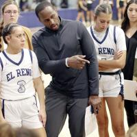 EHS assistant coach Prince Ezeala talks with players