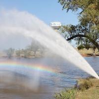 Terrell Thompson and Dillon Macias watch a colorful rainbow form