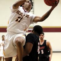 RCC men's basketball_Alexander tries to avoid contact