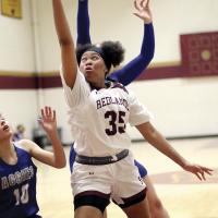 Kellie Eddens dodges two defenders to get off a layup attempt