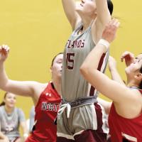 Katelyn Harviston jumps into the air to grab an offensive rebound