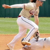 Holden Tate tags out a base runner after he was caught in a rundown