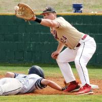 Skyler Fenton eyes a pickoff throw into his glove