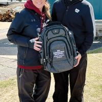 Taylor Neidy Sliauter (left) and Clara Peake hold up the bag presented to the individual medalist from the Hardscrabble Invitational in Arkansas