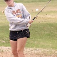 Alison Foley blasts a shot out of the green side bunker