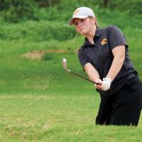 Evelyn Sturgill blasts a shot out of the green-side bunker