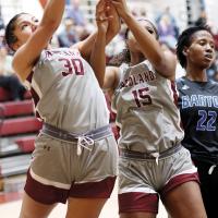 Hannah Harris grabs a rebound in front of teammate Jaiana Wiggins