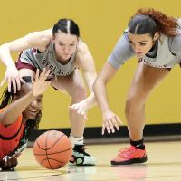 Katelyn Harviston (center) and Alaura Pruitt attempt to get to a loose ball