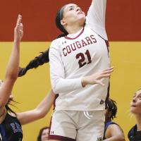 Haven Joseph jumps between defenders to get off a layup
