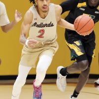 Treston Gage dribbles the ball up the court