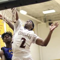 Elijah Herron slam-dunks the basketball