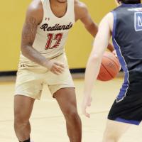 Damond Matthews dribbles in front of a defender