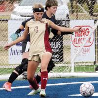 McKenize Simon clears the ball from in front of the net
