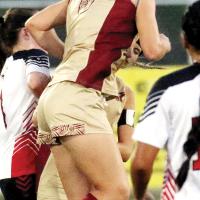 Carlie Golden jumps into the air to use her upper body to deflect a goal kick