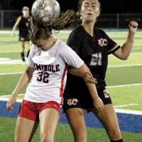 Kylie Thompson locks arms with a Seminole State player