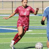 Mercades Sandoval dribbles the ball up the field