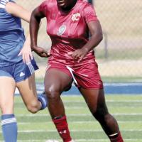 Ashanti Lewis dribbles the ball past a NEO defender