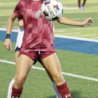 Aracely Martinez uses her body to screen off a Rose State player 