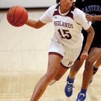 Nyah Banks dribbles past a block