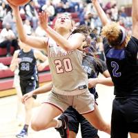 Brooklyn Haywood slices between two Eastern defenders on a shot attempt