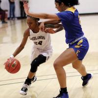 RCC women's basketball_Hopkins drives under block of El Reno native Davis