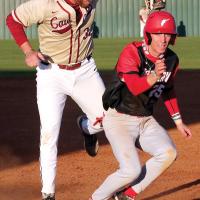 Beau Driver reaches down to tag a base runner on the helmet