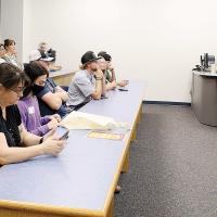 Elise McCauley (right) and Erin Karl engage students during a college orientation session