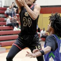 Justice Johnson shoots a running jumper over a defender