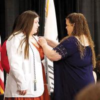 Kassidy Brinlee is pinned by her mother during the nursing pinning ceremony