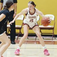 Katelyn Harviston dribbles the ball in front of a defender