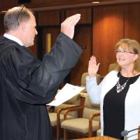 Judge Paul Hesse administers the oath of office to Tracey Rider