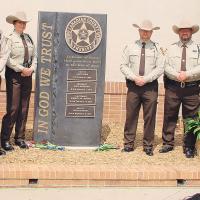 Canadian County Sheriff’s Office personnel stand beside the new Law Enforcement Memorial