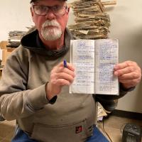 Ray Hosler holds up a notebook