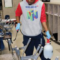 ERPS custodian Hayes sprays down a table
