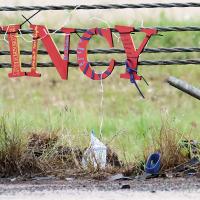 A memorial for El Reno’s Quincy Jones is hung from the cable barrier near the crash site