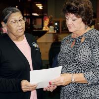 Roberta Hamilton, left, reads the oath of office administered by Laura Kennedy