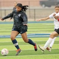 Madison Rochdi dribbles the ball past two U.S. Grant defenders