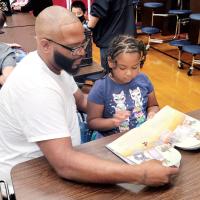 Quayshaun Ross reads with his daughter, Lamayah