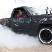 A black truck spins up a cloud of smoke during the Route 66 Burnout