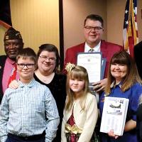 Rukes poses with family and VFW officials