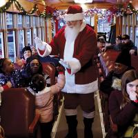 Santa walked down the aisle giving all the kids, young and old, high-fives. (Tribune photographer/Glen Miller)