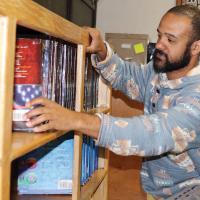 Tyler Hill straightens a line of American history books