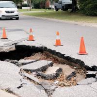 A vehicle approaches the sink hole at Boynton and Shuttee