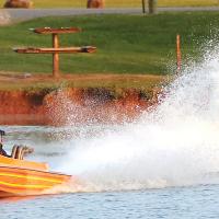 Matt Miller throws off a wall of water behind him as he flies off the start
