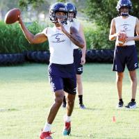 Dorian Plumley sets up to make a throw on a roll-out pattern