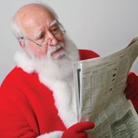 Santa reading newspaper