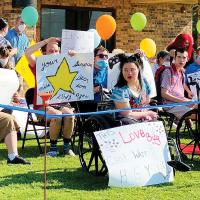 Residents at the CFL held a drive-by parade with signs for family