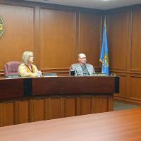 Chris West (right) speaks with Canadian County commissioners