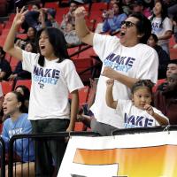 Koneihii Sleeper (left) holds up the 3-pointer sign