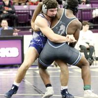 Spencer Davidson grabs an opponent by the waist as he sets up a throw